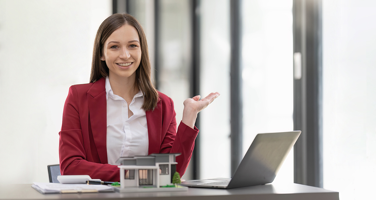 Asian businesswoman making a deal to buy a house or condo inside the office, home insurance concept